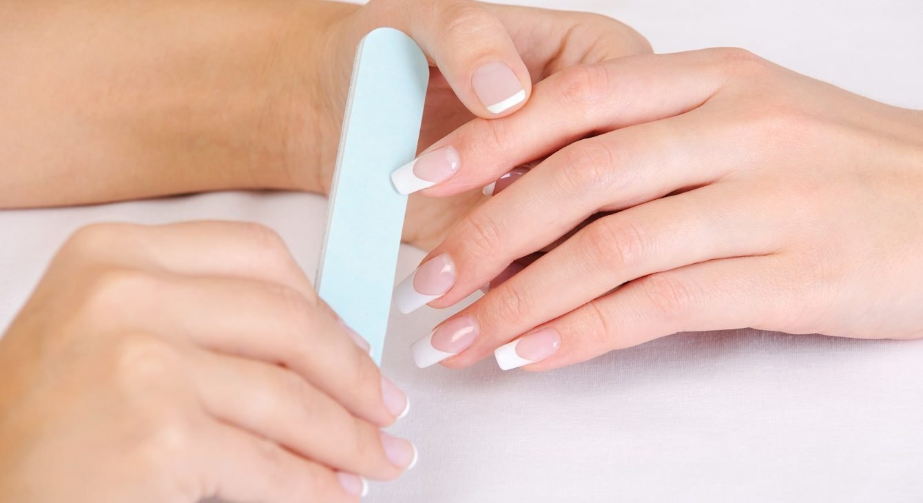 manicurist-doing-polishing-female-fingernails-with-french-manicure manicurist-doing-polishing-female-fingernails-with-french-manicure