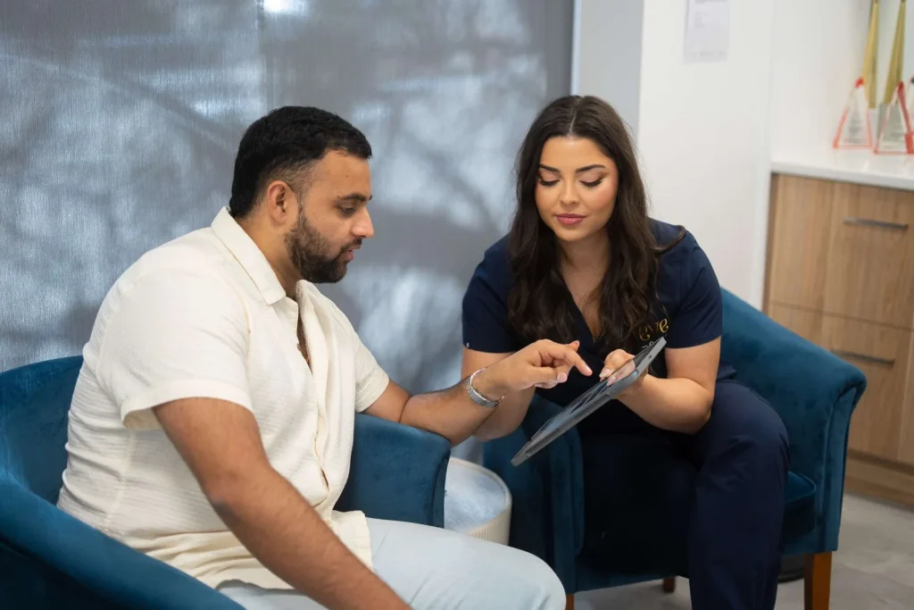A team member and client talking in the clinic lounge