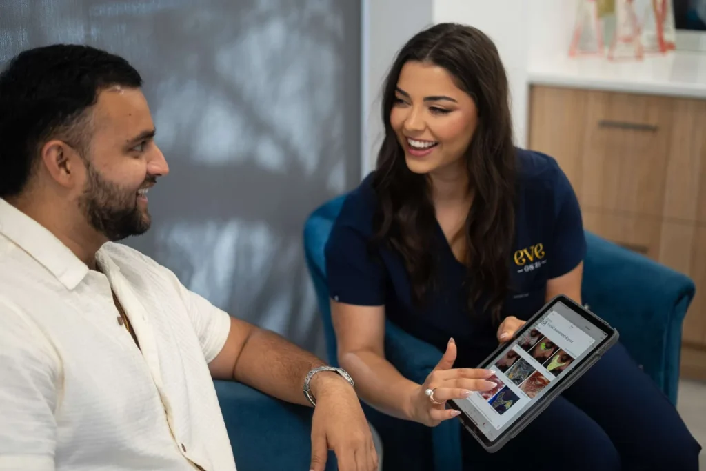 A team member reviewing a consultation with a client on a tablet