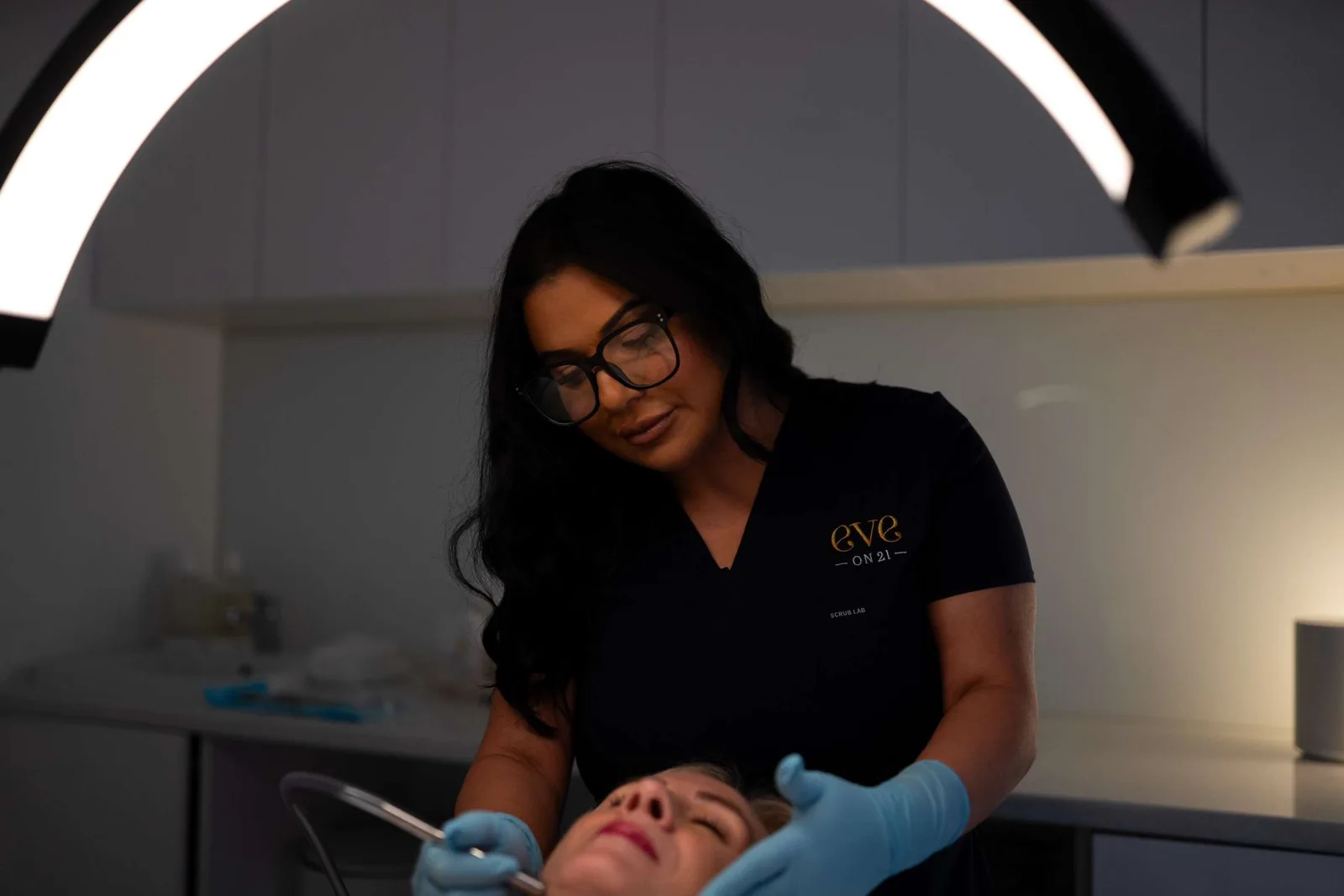A therapist carrying out a skin treatment