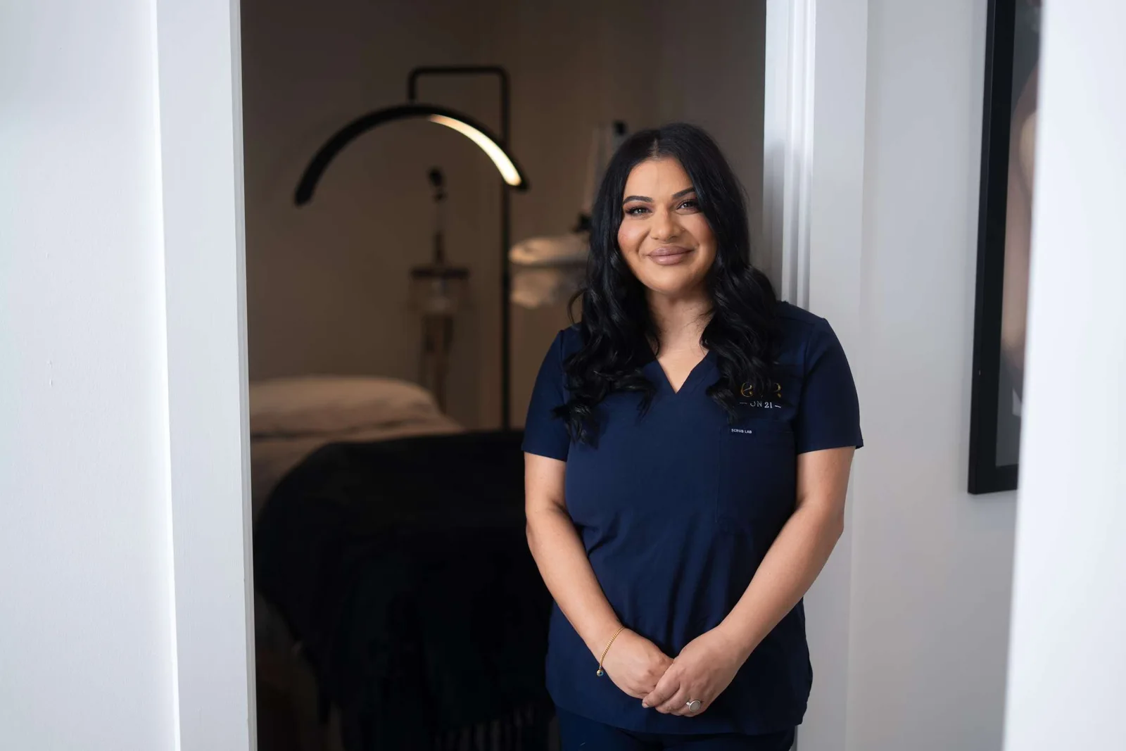 A team member at the doorway of a treatment room